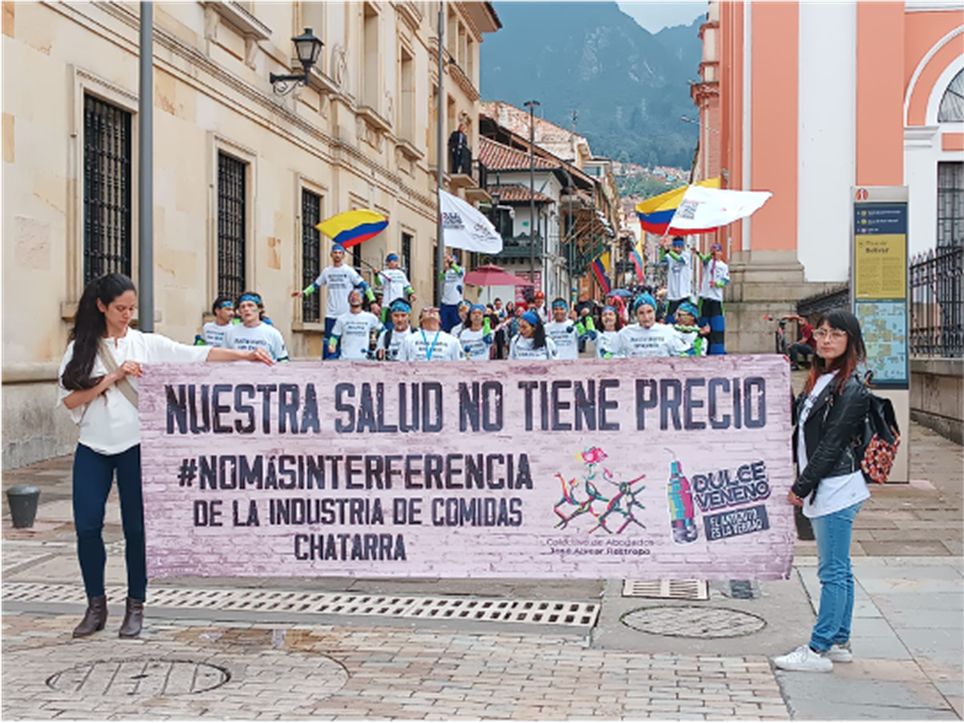 Sweetened beverage tax advocates in Colombia with a sign.